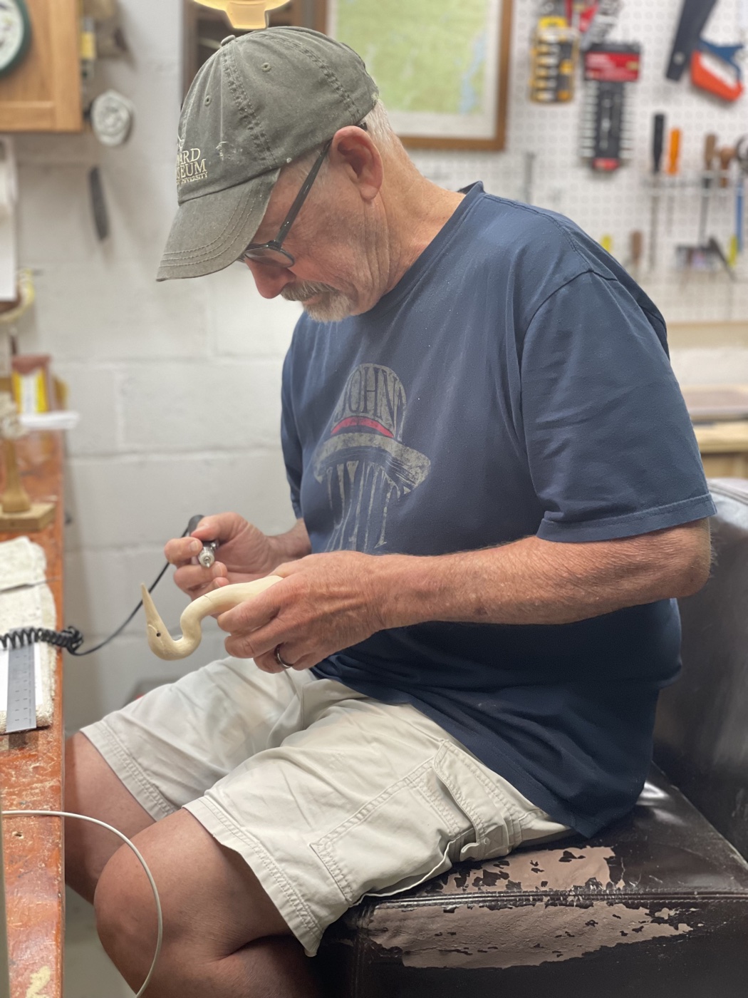 Kenny Jewell carving a bird at his workbench