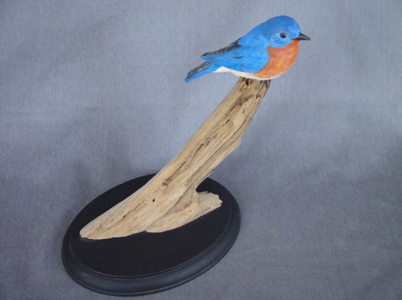 Carved eastern bluebird on a branch